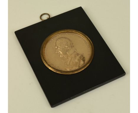 Lord Nelson. A 19th century circular gilt metal portrait relief of Lord Nelson with the wording 'Admiral Lord Nelson Duke of 