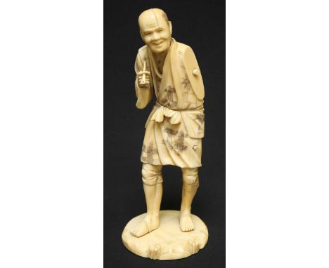 A Japanese Meiji period carved ivory okimono figure of a man smoking a pipe (left arm missing), 22cm high