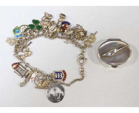 A silver and enamel charm bracelet, together with a modern silver British Airways Concorde pill box. (2)