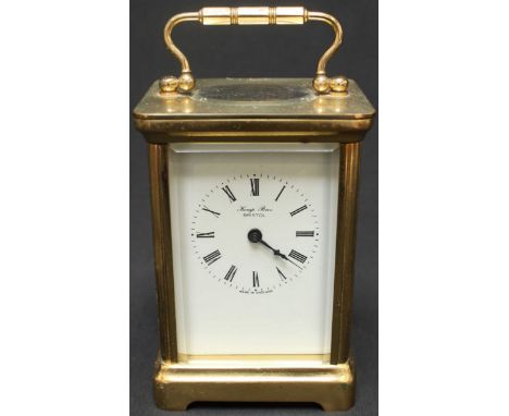 A 20th century brass carriage clock by Kemp Brothers of Bristol, with white enamel dial and black Roman numerals, within a br