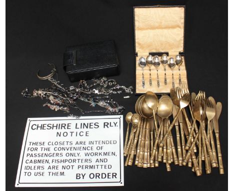 A collection of costume jewellery, together with a set of silver plated spoons, and a set of cutlery, and a reproduction enam