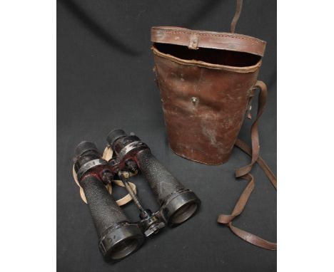 A pair of Admiralty pattern Burr & Stroud 7x50mm binoculars with integral light filters, in a leather case