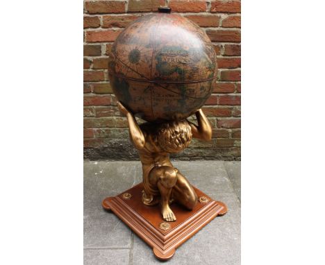 A large composite Atlas drinks globe,the globe with rising top, fitted interior and held aloft by Atlas