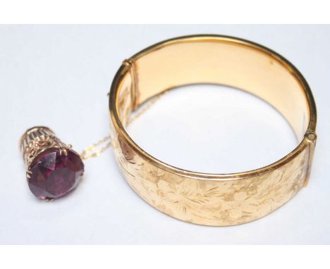 A 9ct gold and amethyst coloured stone pendant, together with a rolled gold cuff bangle. (2)