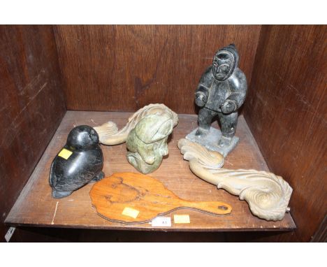 A group of three inuit hard stone carvings of two figures and a seal, and a pair of gilded metal dolphin wall light brackets,