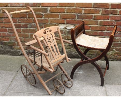 An Edwardian mahogany folding cross frame piano stool, together with a Edwardian four wheel pram. (2)