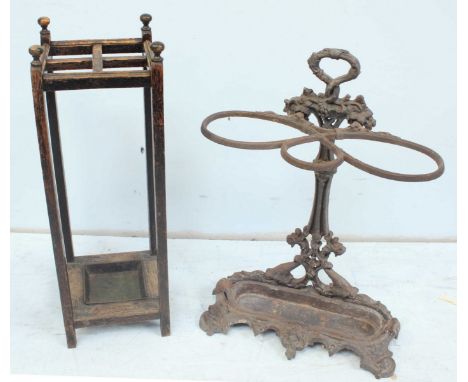 A shaped and moulded cast iron umbrella stand decorated with flower and lions heads etc together with an oak stick stand with