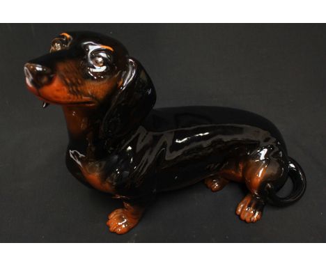 A large Beswick pottery model of a seated Dachshund. Nose to tail: 42 cm