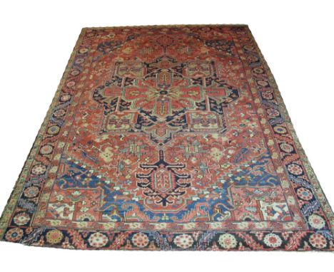 ANTIQUE PERSIAN HERIZ CARPET, 369cm x 274cm, circa 1890, traditional geometric designs on a terracotta field. 