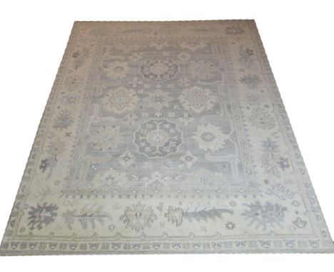 OUSHAK SILVER EN GRIS CARPET, 302cm x 240cm, all over palmette and vines inside a corresponding oversized border. 