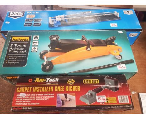 A collection of tools to include Halfords 2 Tonne trolley jack together with a carpet installer and a Macallister Tile Cutter