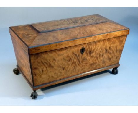REGENCY STYLE SATINWOOD SARCOPHAGUS SHAPED TEA CADDY HINGED COVER DISCLOSING TWO HINGED COVERED CADDIES AND A LATER BOWL, WIT
