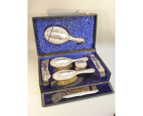 EDWARDIAN SILVER DRESSING TABLE SET COMPRISING PAIR OF HAIR BRUSHES, PAIR OF CLOTHES BRUSHES, HAND MIRROR AND A CYLINDRICAL B