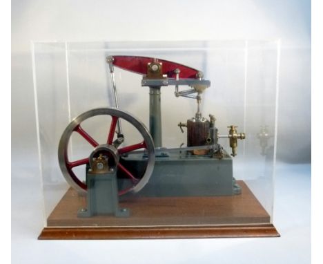 A CAST IRON SCALE MODEL OF A STUART BEAM ENGINE, PAINTED GREEN AND RED WITH A SIX SPOKE FLY WHEEL AND VERTICAL OSCILLATING PI