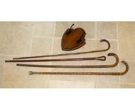 WALKING STICK WITH SILVER COLLAR, TWO OTHER STICKS, CANE AND A WALNUT SHIELD HAT AND COAT RACK [5]