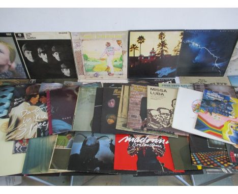 A collection of 12" vinyl records including Queen, Pink Floyd, Supertramp, The Rolling Stones, The Who, The Eagles, David Bow