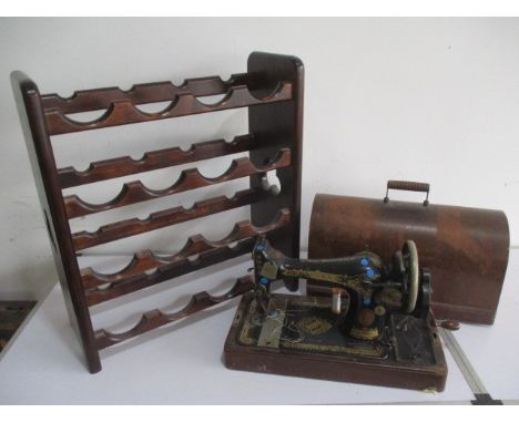 A vintage Singer sewing machine in case, along with a wine rack