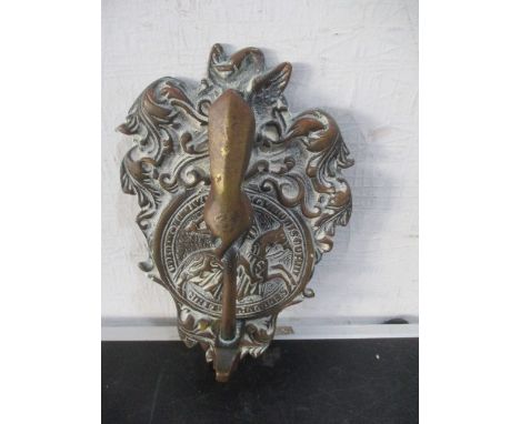 A brass door knocker in the form of a hand holding a hammer- possibly Masonic