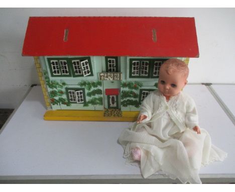 A vintage dolls house with a selection of furniture included, along with a baby doll