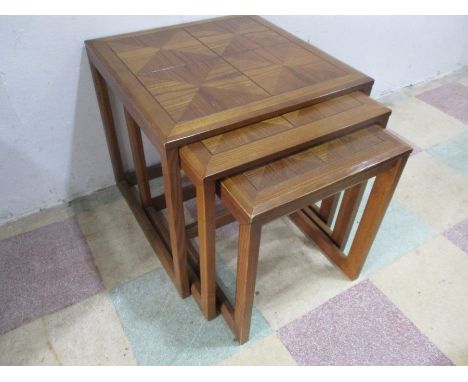 A G plan nest of three tables with tile effect decoration