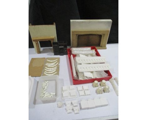 A collection of dolls house plaster architectural mouldings including pillars and columns along with "The Phoenix Kitchener",