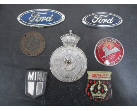 A collection of vintage car badges including an Edward VIII coronation, 1931, Armstrong Siddeley, Frazer Nash BMW etc