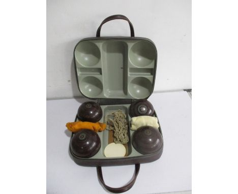 A set of four vintage Hemselite bowls (size 5) in leather carry case