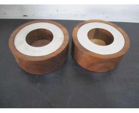A pair of Linley walnut and polished nickel tea light holders