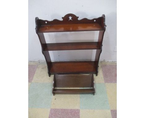 An Art Nouveau hanging wall shelf, along with a book rest