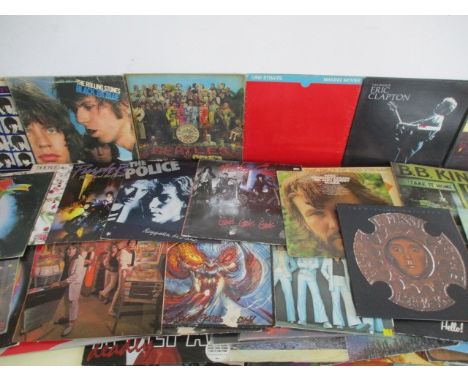 A large collection of 12" vinyl records including The Rolling Stones, The Beatles, The Eagles, Dire Straits, The Who, ZZ Top,