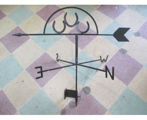 A wrought iron weather vane