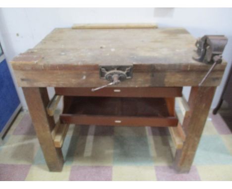 A vintage workbench with a vice attached