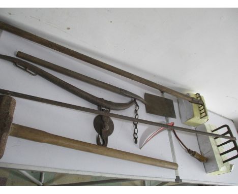 A collection of vintage tools including a shovel, sledgehammer etc