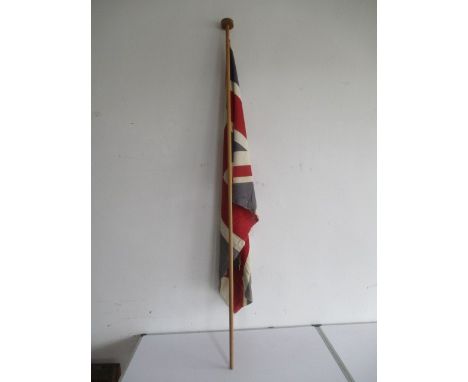 A vintage union flag on wooden pole