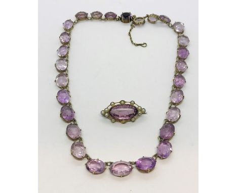 A vintage amethyst coloured necklace in SCM setting along with a similar brooch with seed pearl edging 