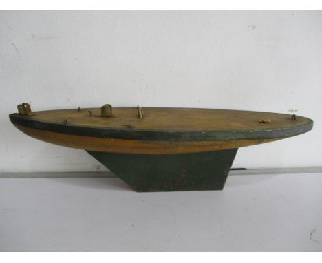 A vintage wooden model yacht hull with metal keel