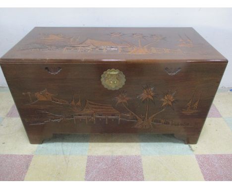 A camphor wood trunk with carved Chinoiserie decoration