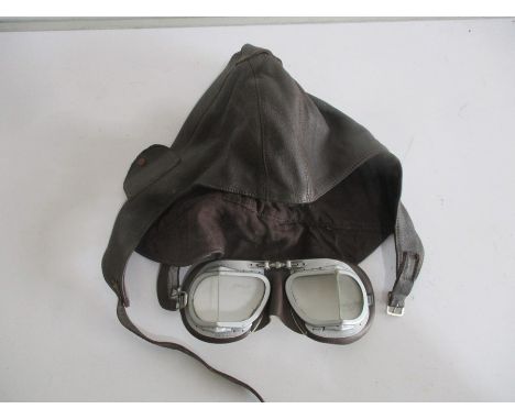 A vintage leather motorcycle hat, along with Halcyon motorcycle goggles
