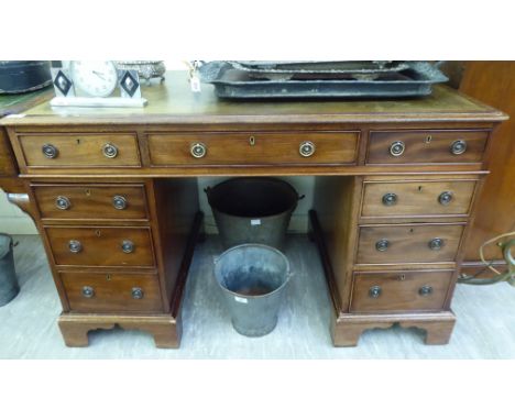 A late Victorian mahogany nine drawer, twin pedestal desk, raised on bracket feet  29''h  47''w       LSM