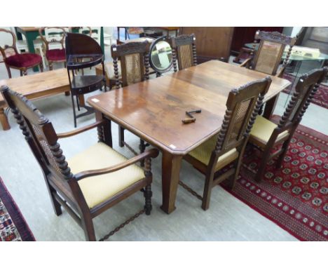 A 1920s stained oak dining table, the top with a thumb moulded edge and canted corners, raised on block, tapered legs  28''h 