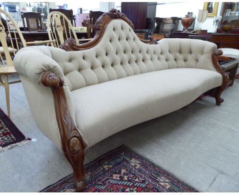 A modern Victorian style mahogany showwood framed three person settee, the part button, beige coloured fabric back and seat r