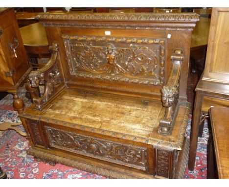 Good quality Victorian walnut hall bench with a carved back and lion mask arms above a box seat