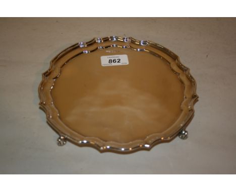 Sheffield silver circular shaped edge salver on four supports, makers mark R. and D. 
