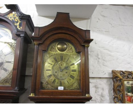 18th Century oak longcase clock, the pagoda hood enclosing a brass dial with pierced spandrels, the chapter ring having Roman