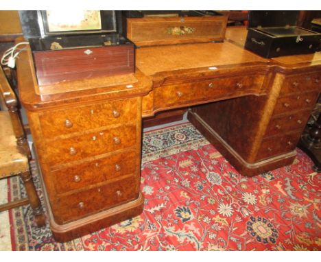 19th Century burr walnut inverted breakfront pedestal desk having three section leather inset top above an arrangement of nin