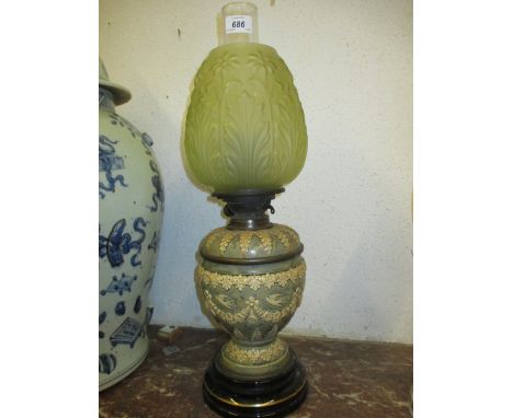 19th Century stoneware oil lamp with floral relief moulded decoration, complete with a green glass shade and a clear glass ch