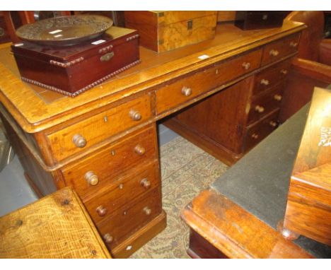 Late 19th / early 20th Century oak pedestal desk, having an arrangement of nine drawers with later knob handles with inlaid d