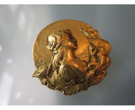 French Art Nouveau circular gold brooch decorated in relief with head and shoulder portrait of a girl, signed E. Dropsy