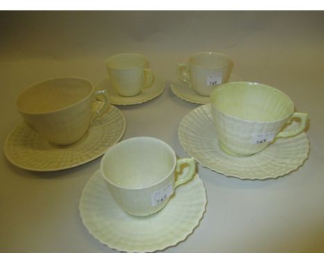 Group of five various Belleek porcelain tea cups and saucers (brown mark)