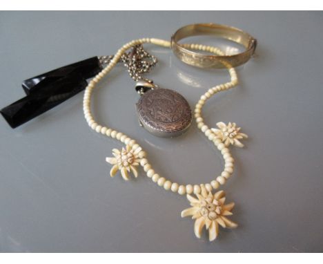 Victorian silver locket on chain, carved ivory pendant necklace, two jet brooches and a rolled gold bangle